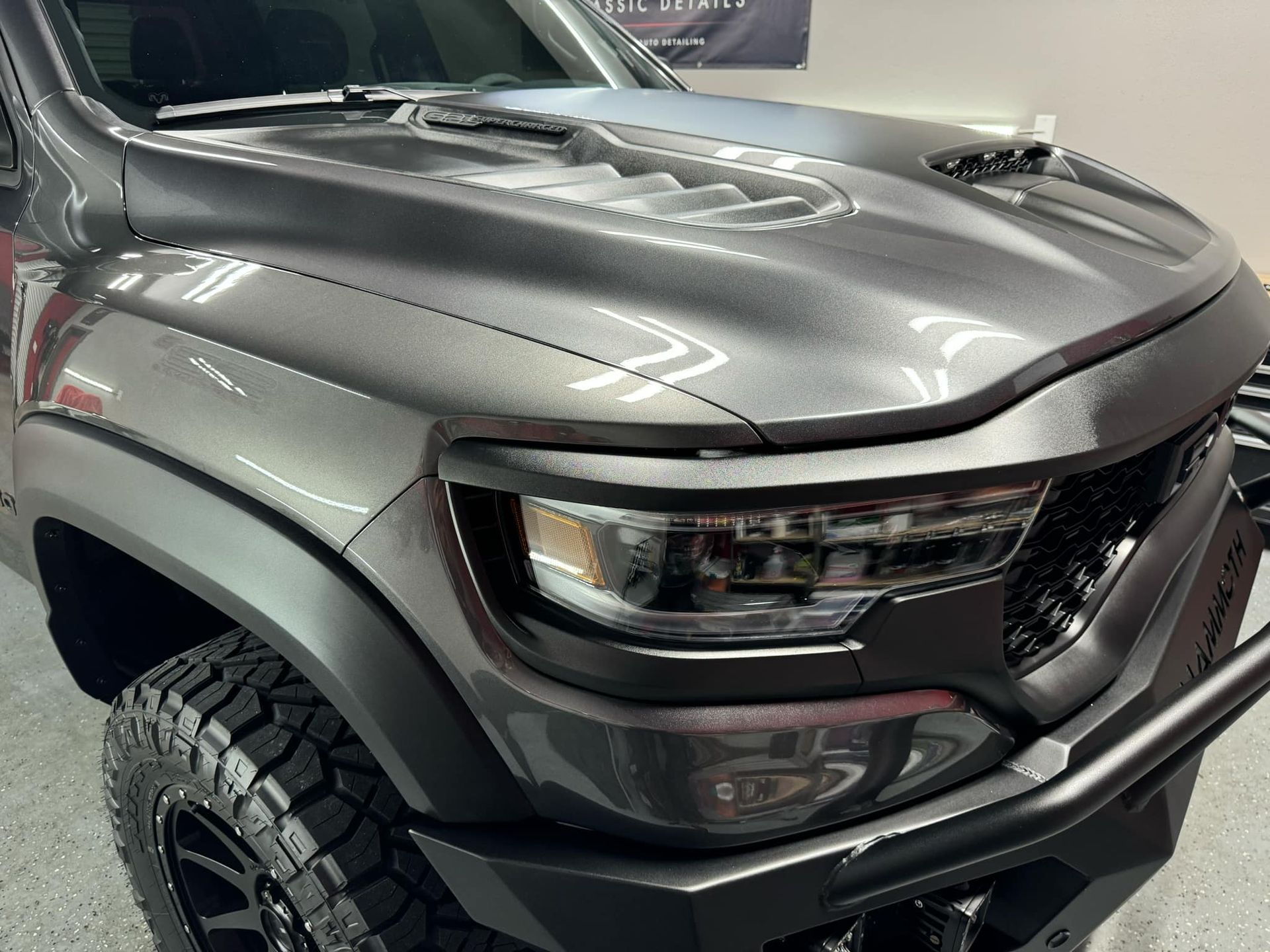 A black bmw x7 is parked in a garage.