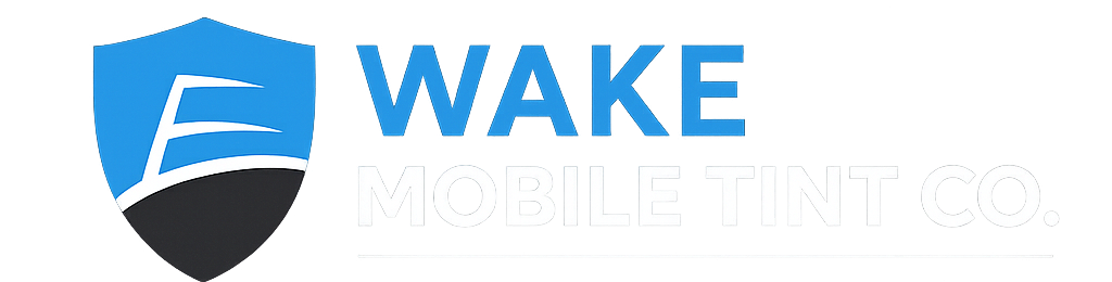 Logo for Wake Mobile Tint Co., featuring a blue shield with a white 