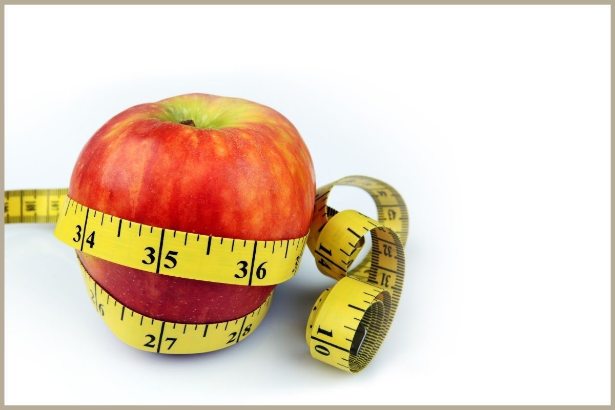 apple surrounded by measuring tape