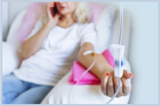 A woman examines her reflection in a mirror at a premier personalized medical care clinic.