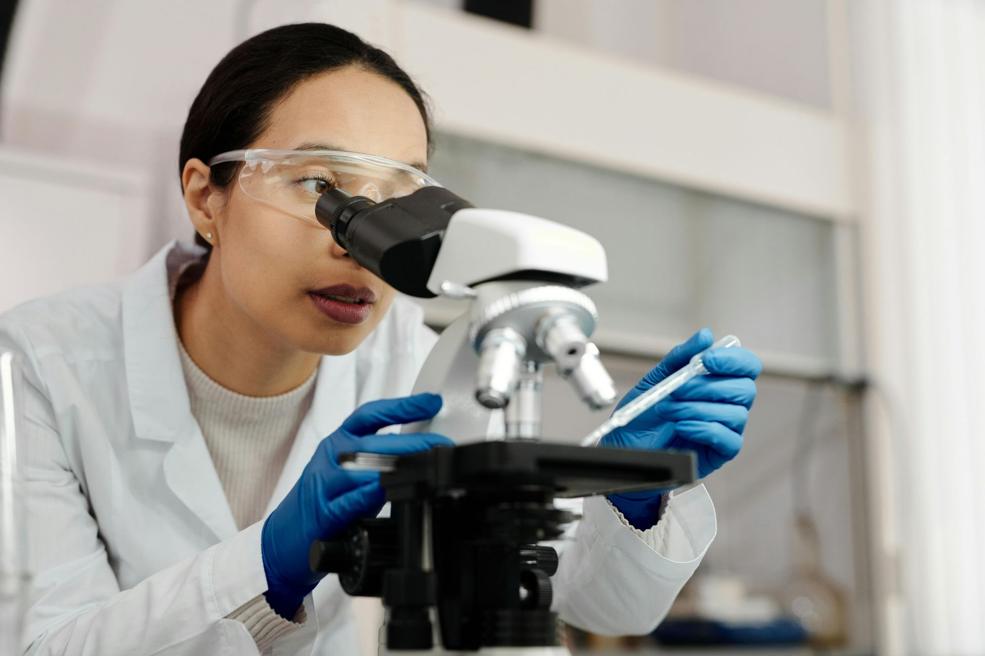 Doctor smiling, reviewing chart with patient in office. White coat, stethoscope, bright setting.