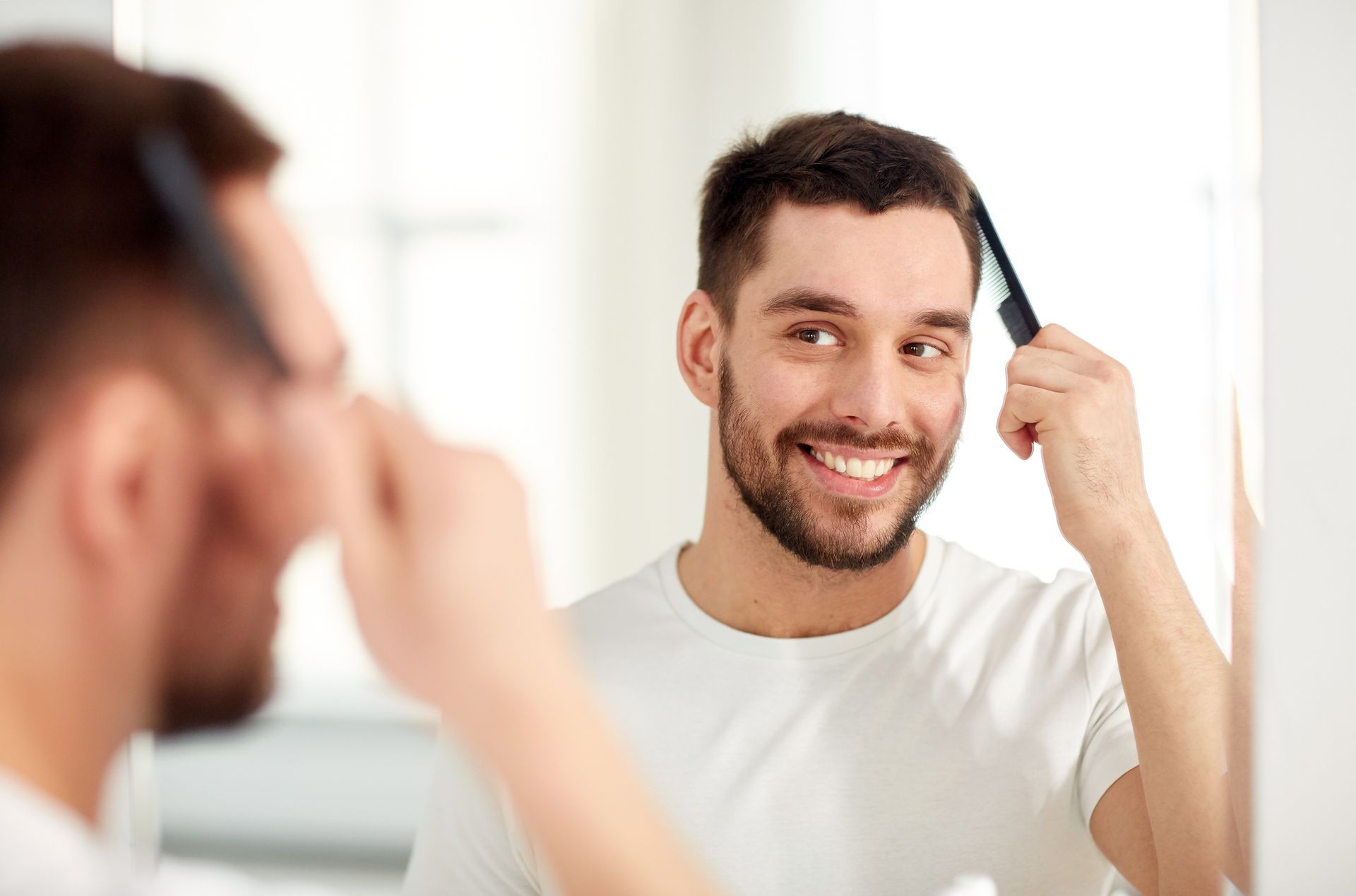 Doctor smiling, reviewing chart with patient in office. White coat, stethoscope, bright setting.