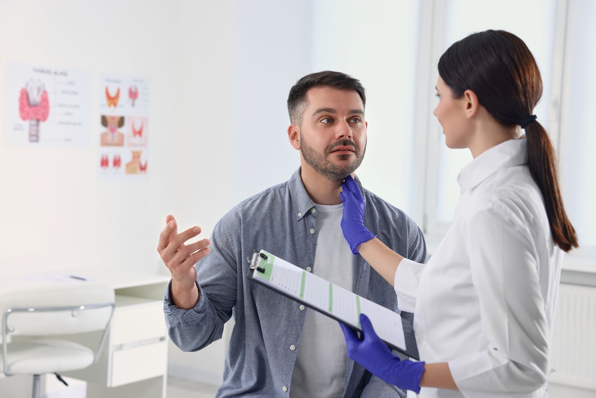 Doctor smiling, reviewing chart with patient in office. White coat, stethoscope, bright setting.