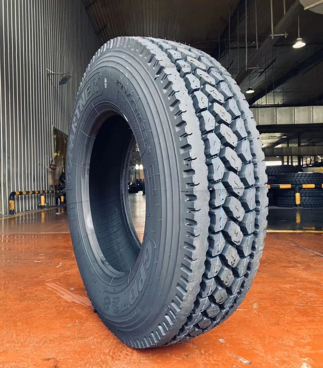 a Starlux D271 drive tire sitting on a red floor in a warehouse.
