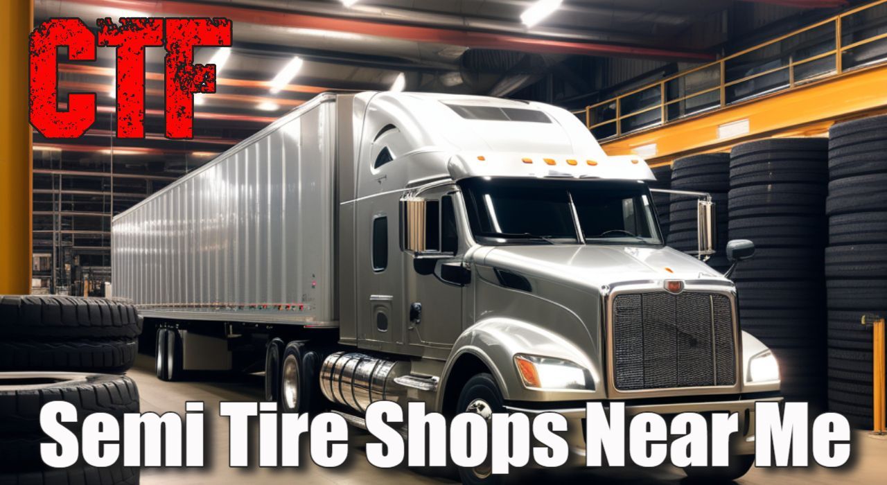 a semi truck is parked in a warehouse next to a pile of tires .