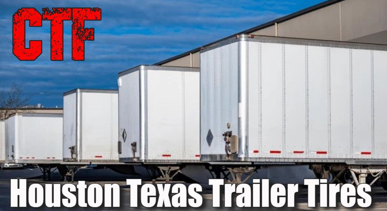 a row of white trailers are parked in front of a building.