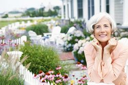 Smiling woman in front of garden