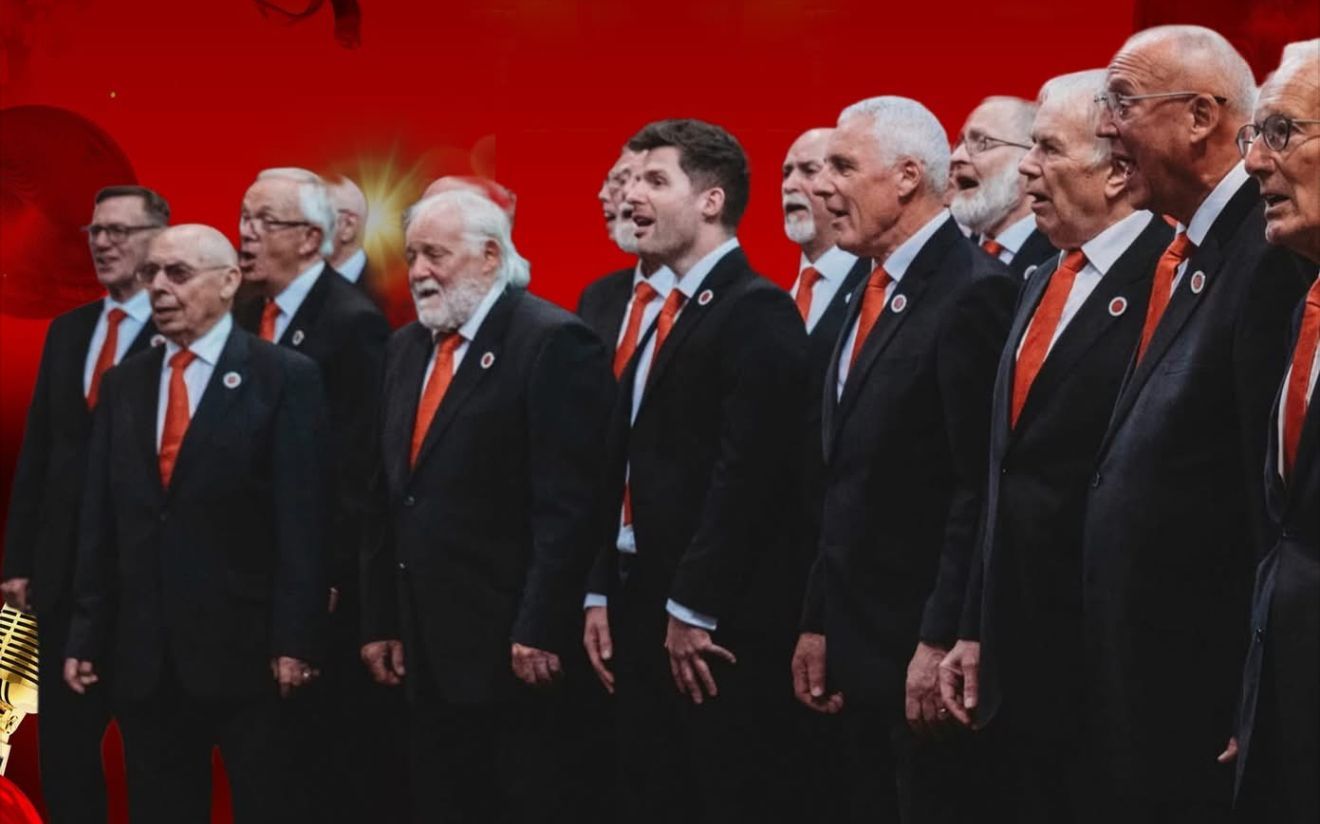 Rossendale Male Voice Choir at the Boot & Shoe, Waterfoot. Choir in black suits with red ties singing on stage