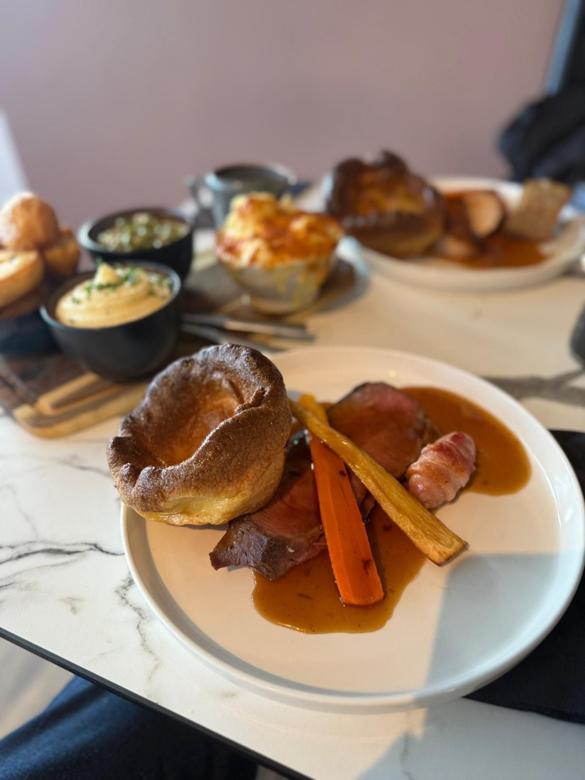 Boot & Shoe Bar & Kitchen gift voucher. White card with gold lettering, amidst festive decorations.