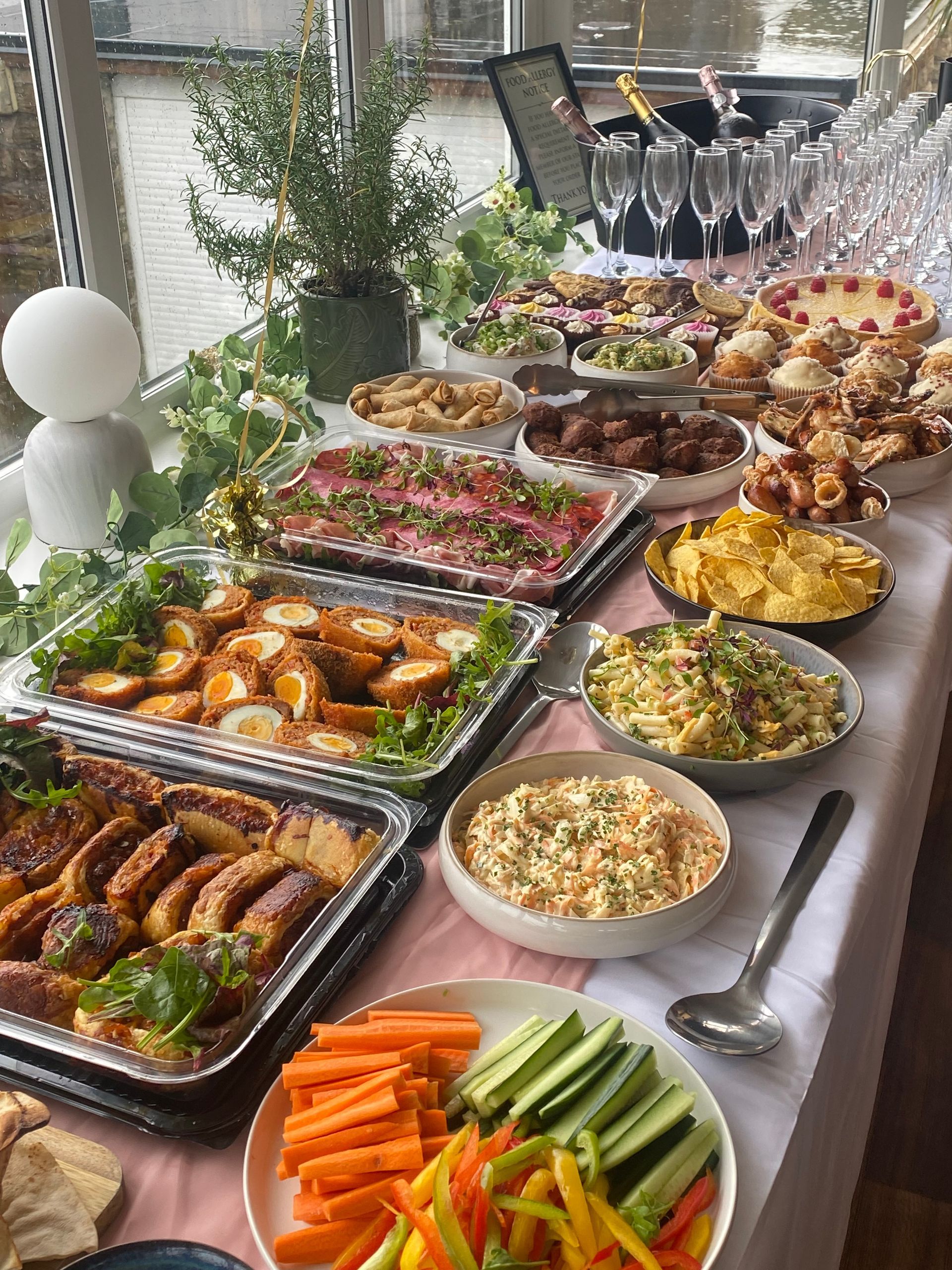 Buffet table - food and drinks, including pastries, and champagne glasses. Boot the Boot & Shoe for any occasion. Functions.