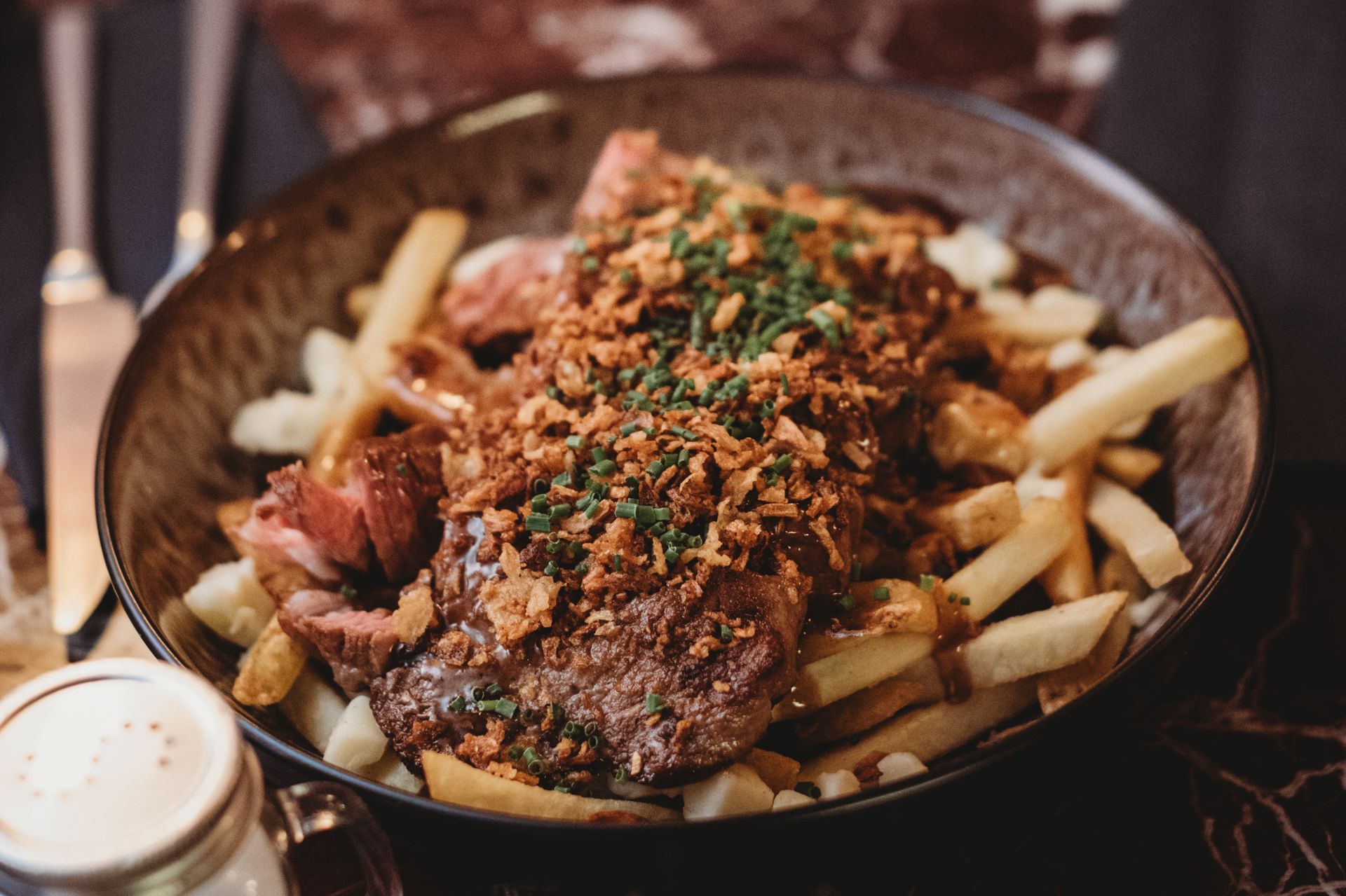 Steak frites dish: steak on fries, gravy, fried onions. Food at the Boot & Shoe, Waterfoot, Rossendale