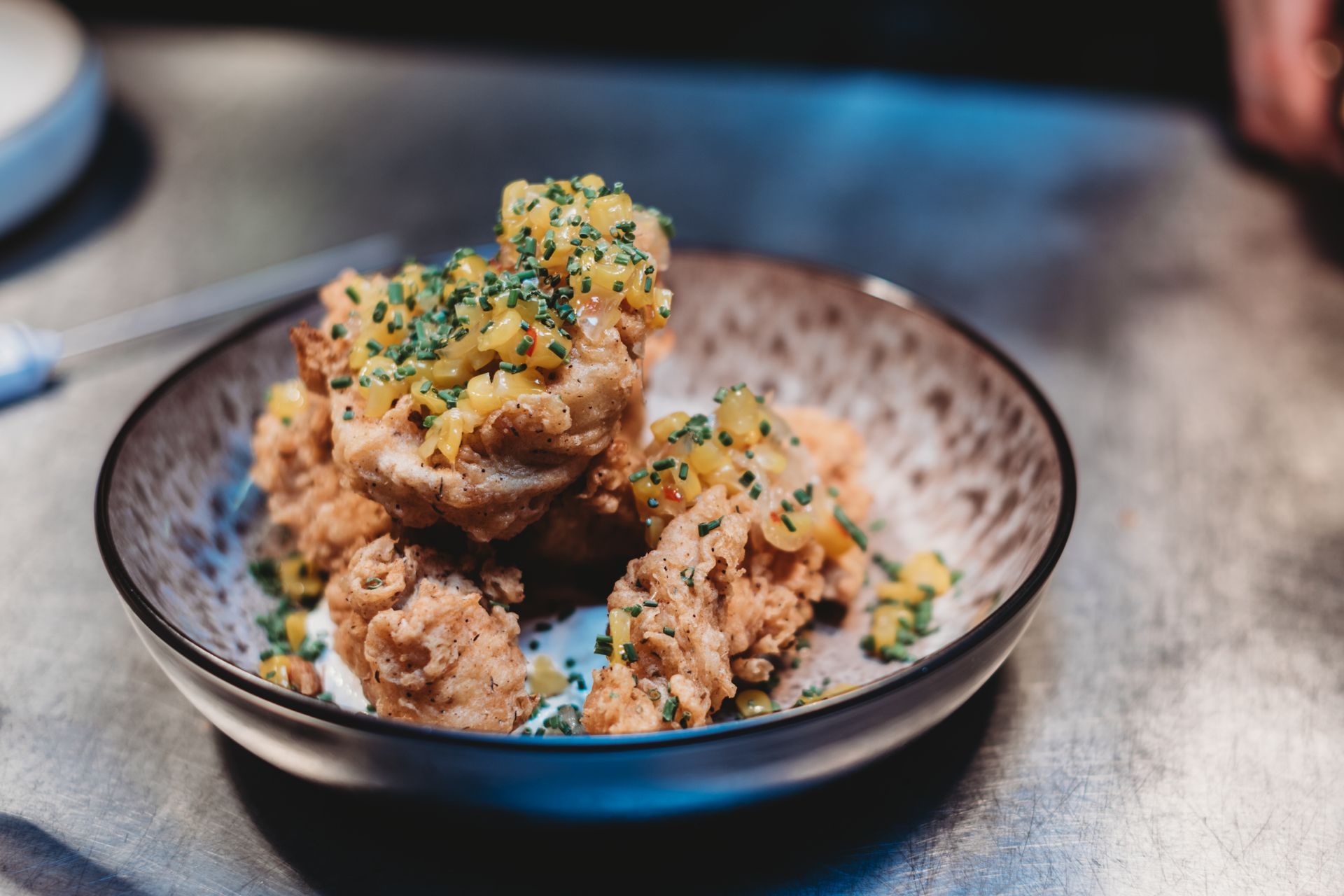 Fried chicken pieces topped with diced vegetables and herbs. Food at the Boot & Shoe, Waterfoot, Rossendale