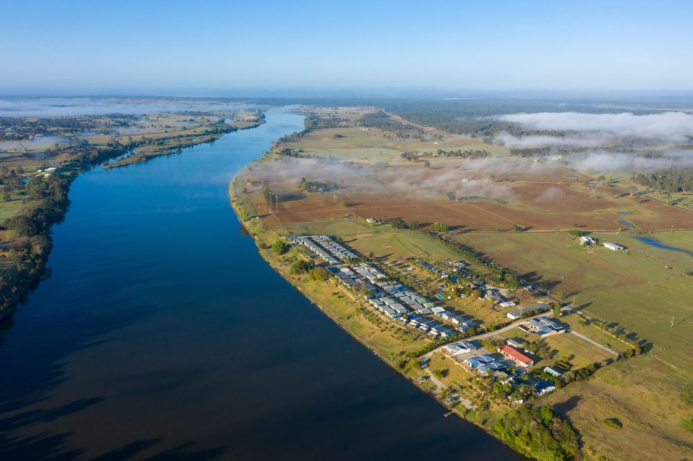 Aerial View of a Wide River Flowing Through a Rural Landscape — Pootanky Grafton, NSW