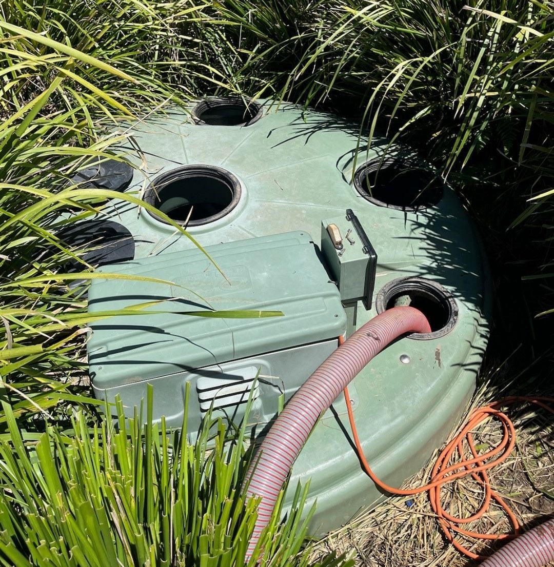 A Man Is Pumping A Hose Into A Septic Tank — Pootanky Bangalow, NSW