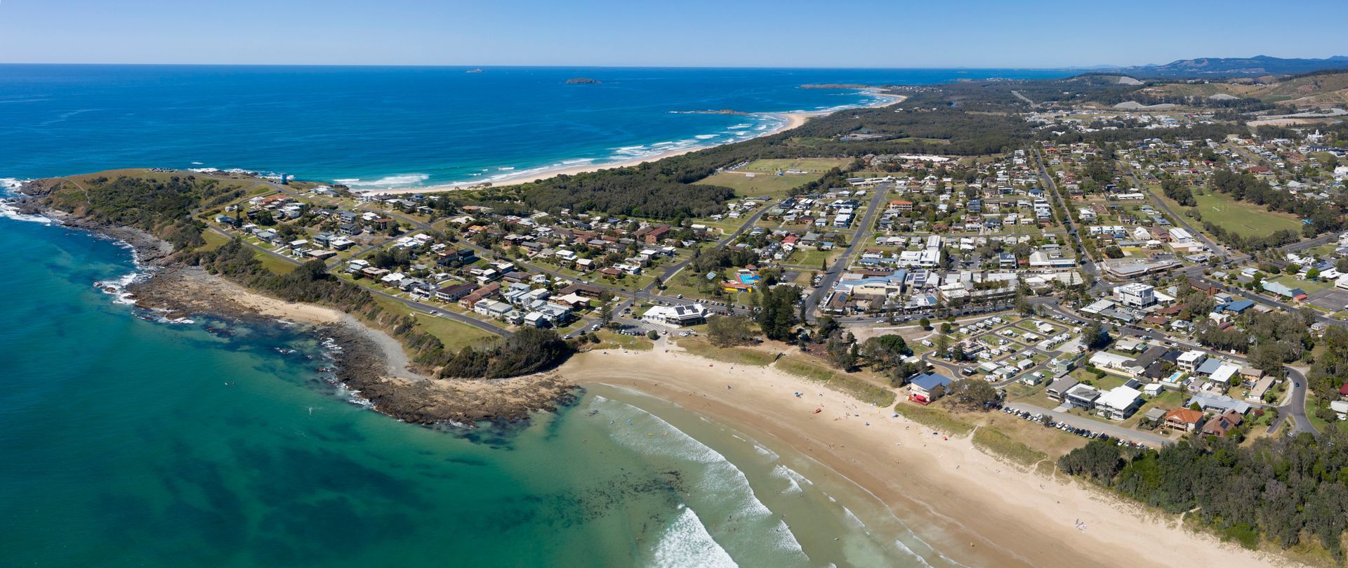 Aerial View of a Coastal Town With a Sandy Beach, Ocean, and Houses — Pootanky Woolgoolga, NSW