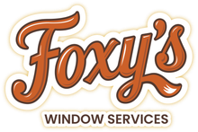 The logo for foxy 's window services is a sticker.