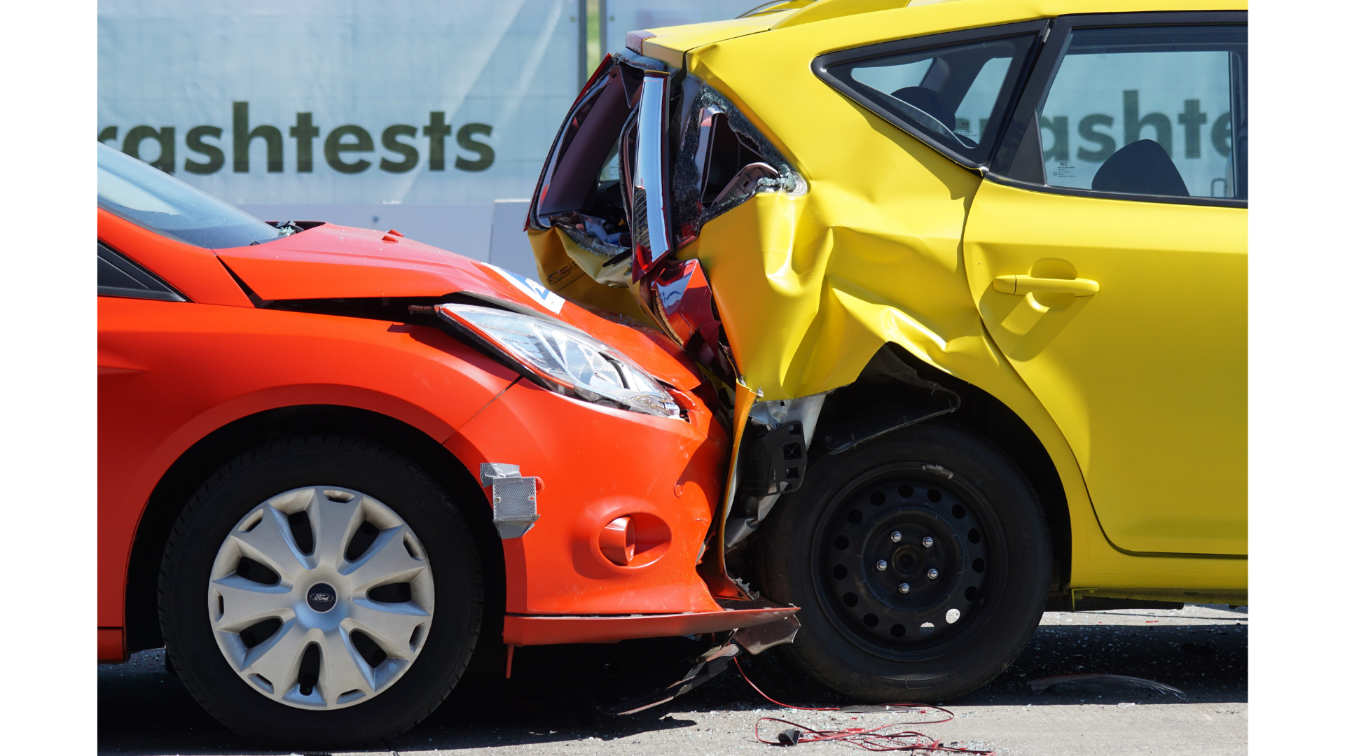 A red car and a yellow car are crashed into each other.