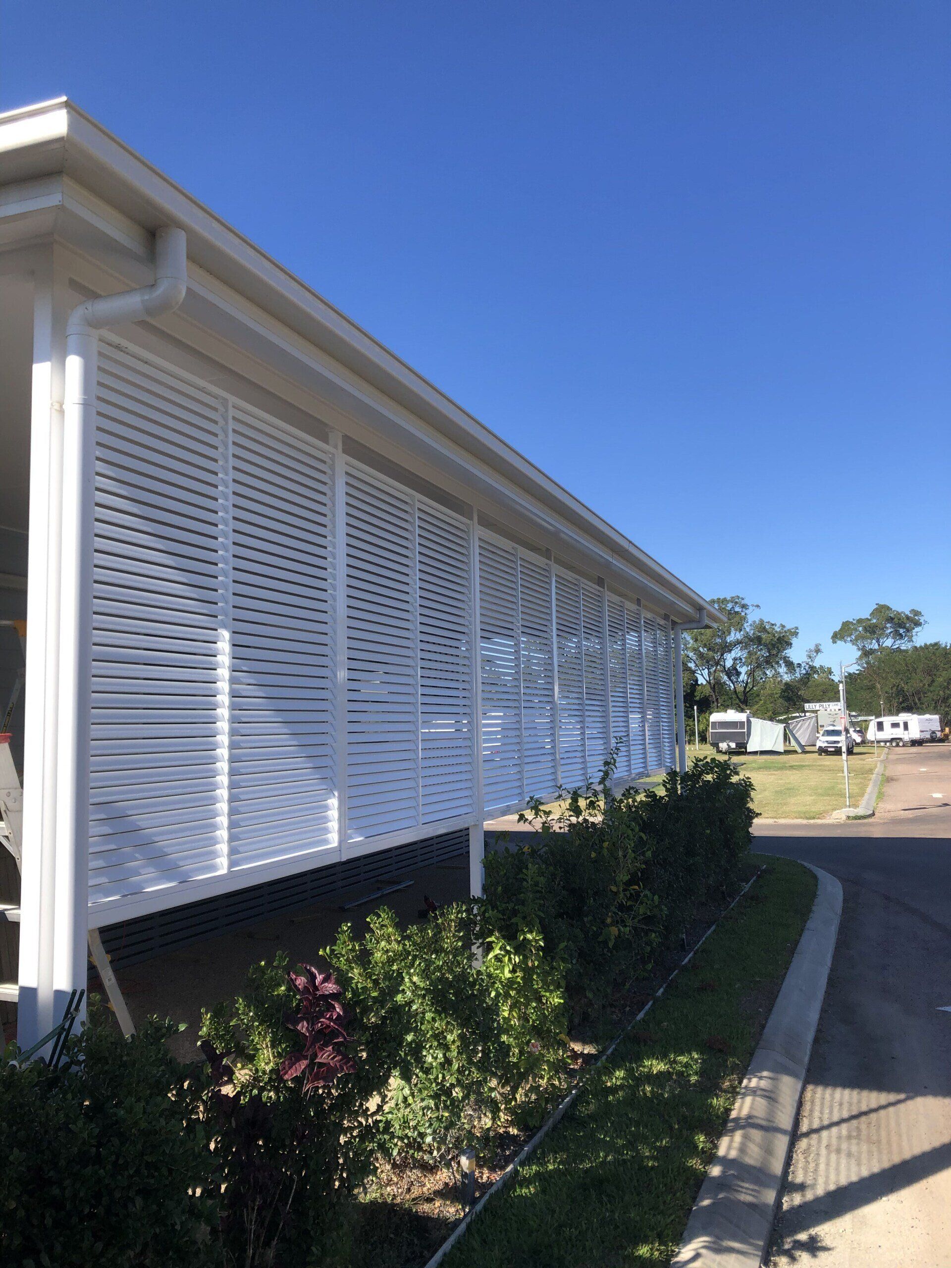 A White House With a Porch and a Blue Sky in the Background — Lifestyle Aluminium Lattice in West End, QLD