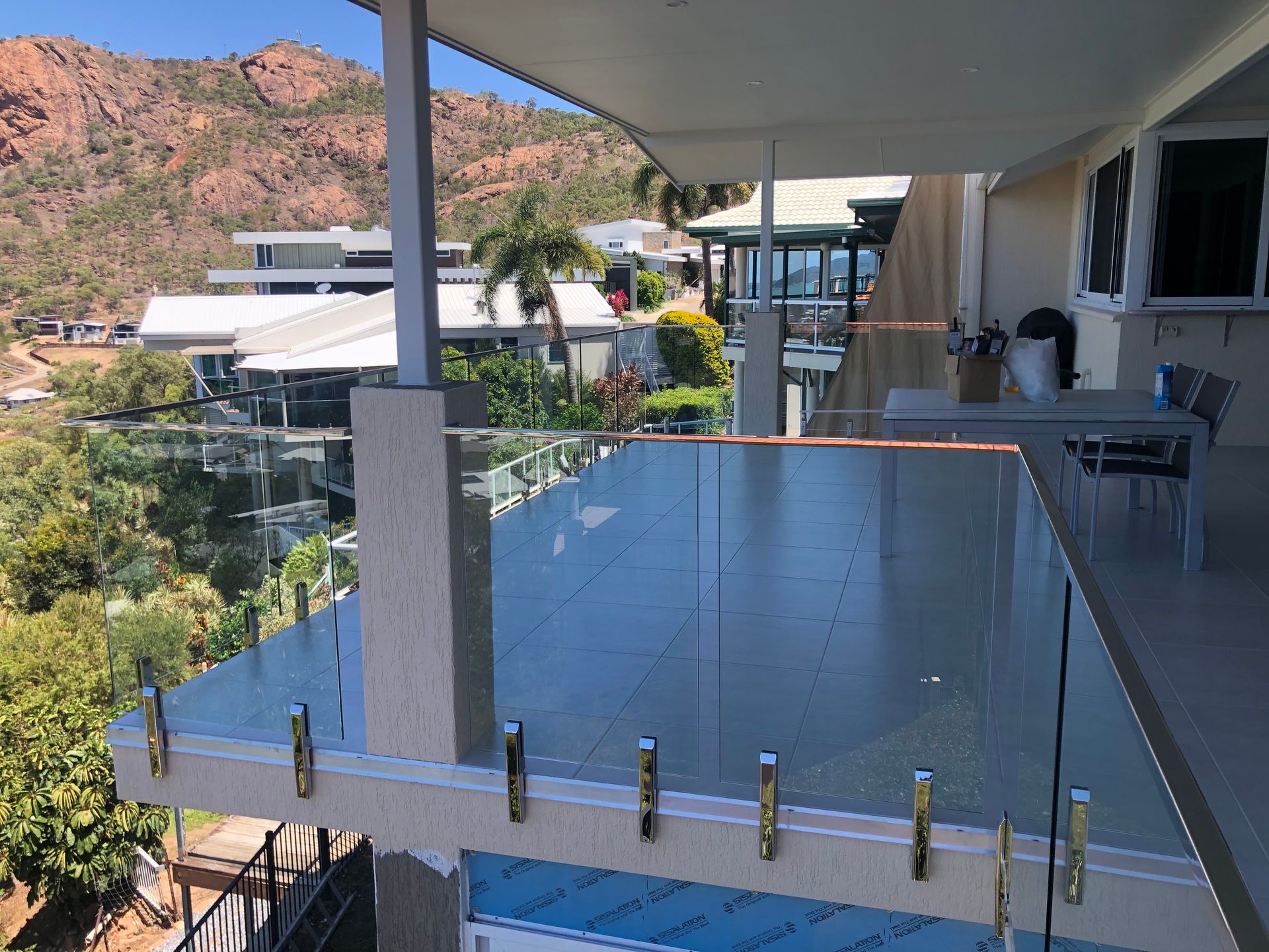 Balcony With Glass Railing Overlooking a Neighborhood — Lifestyle Aluminium Lattice in Kirwan, QLD