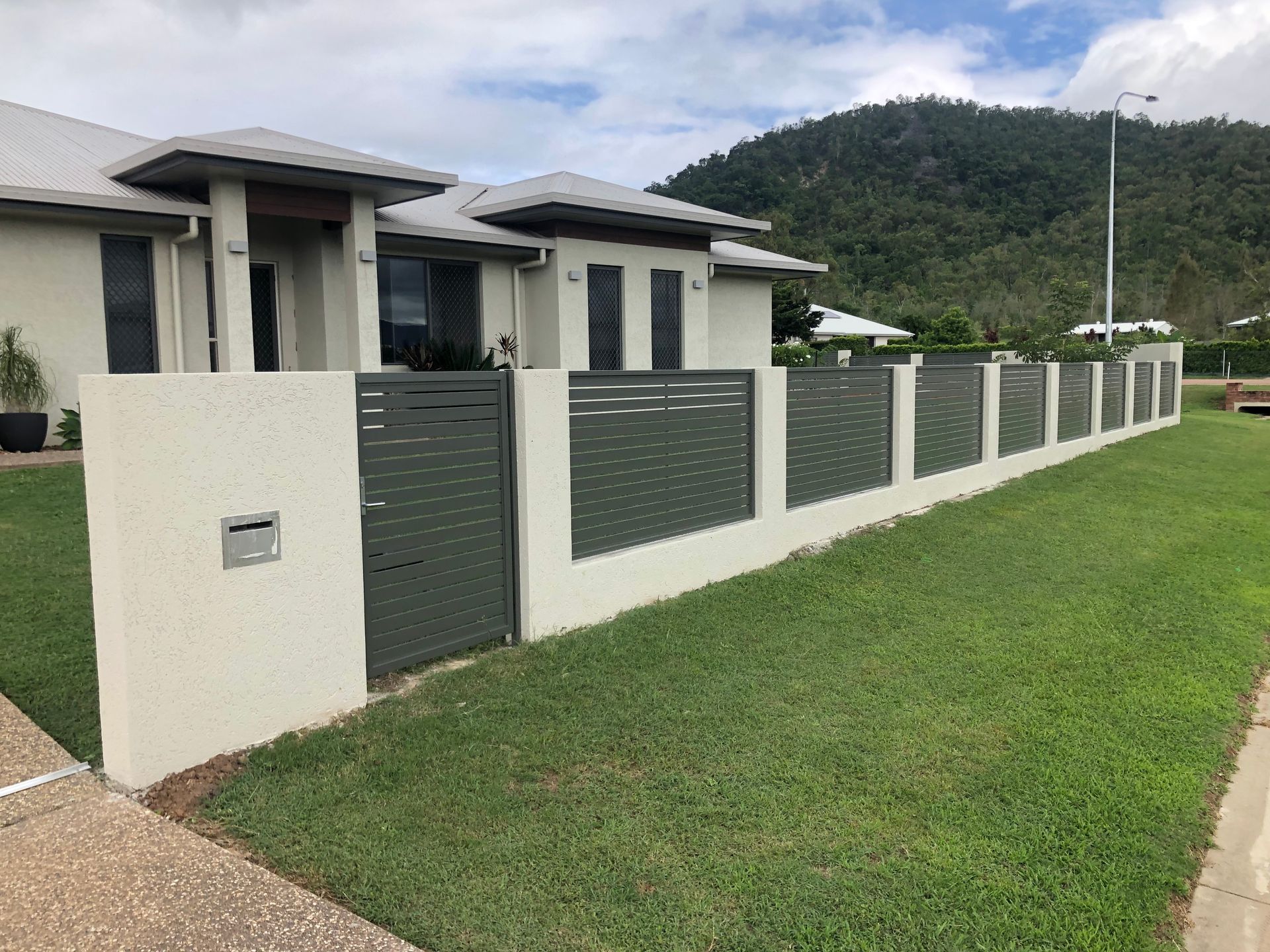 Modern Home With Gray Walls, a Matching Fence — Lifestyle Aluminium Lattice in Rasmussen, QLD
