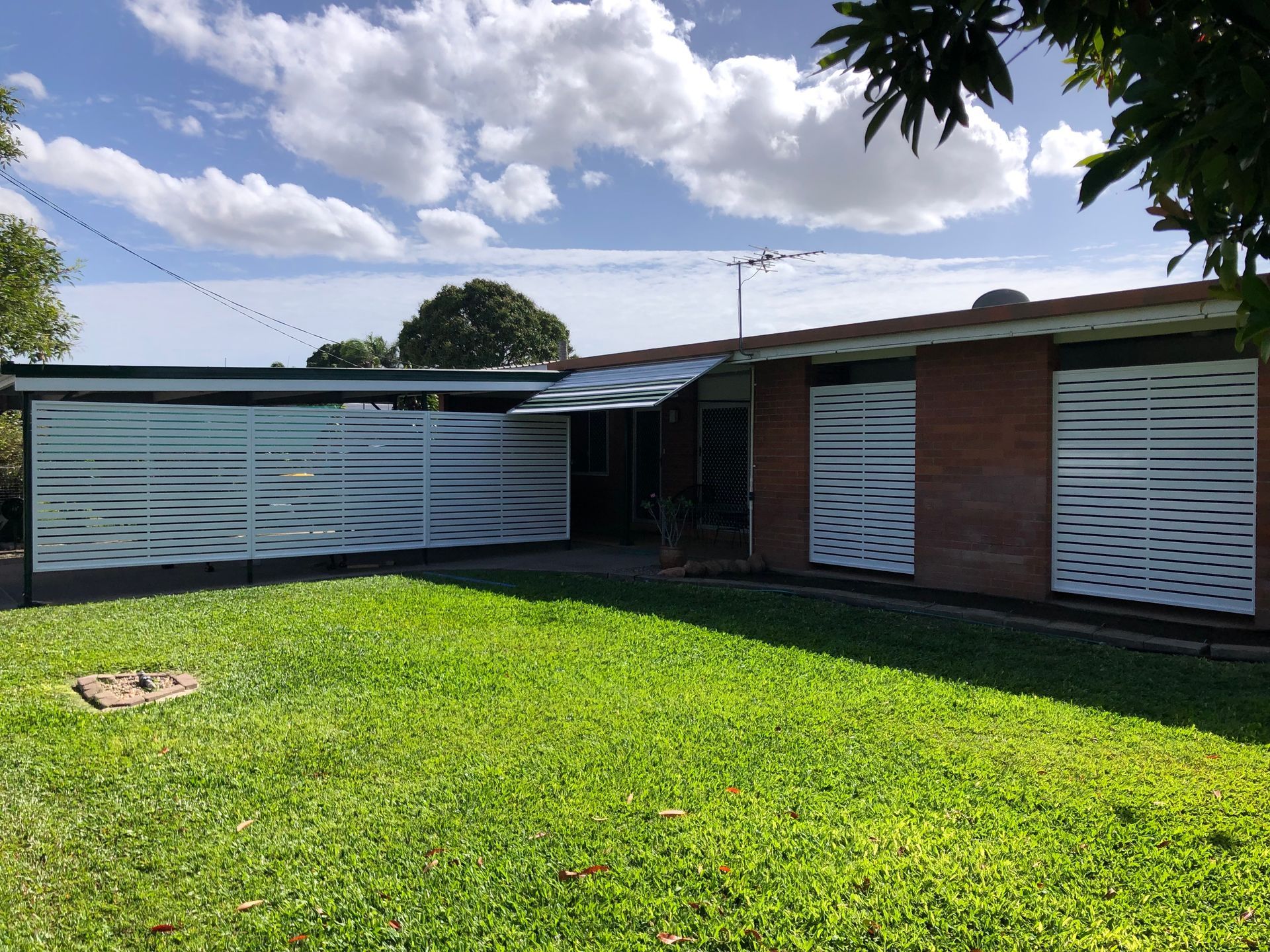 A Single-story Brick House With White Slatted Window — Lifestyle Aluminium Lattice in Annandale, QLD
