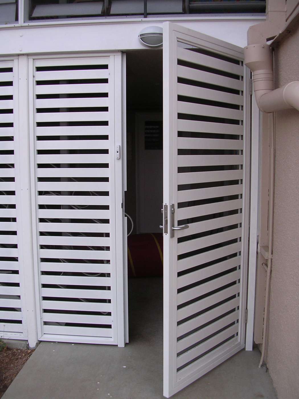 White Slatted Door Open, Revealing Interior — Lifestyle Aluminium Lattice in West End, QLD