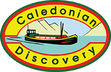 Caledonian Discovery logo: a green ship on water, mountains in the background, oval with yellow, red, and green borders.