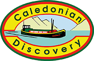 Caledonian Discovery logo: a green ship on water, mountains in the background, oval with yellow, red, and green borders.