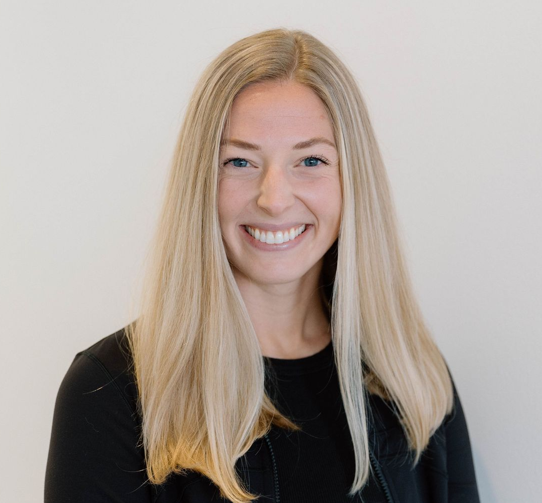 Megan Cox, manager, co owner BYB OKC Blonde woman smiling, looking at the camera, in a well-lit, modern space.
