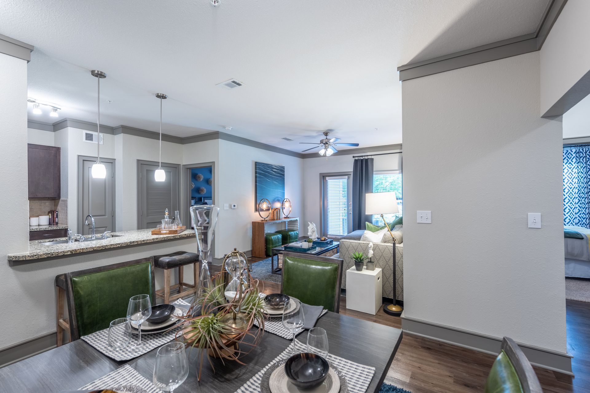 There is a dining table and chairs in the middle of the room at Marquis Seven Lakes offers apartments for rent in Katy, TX.