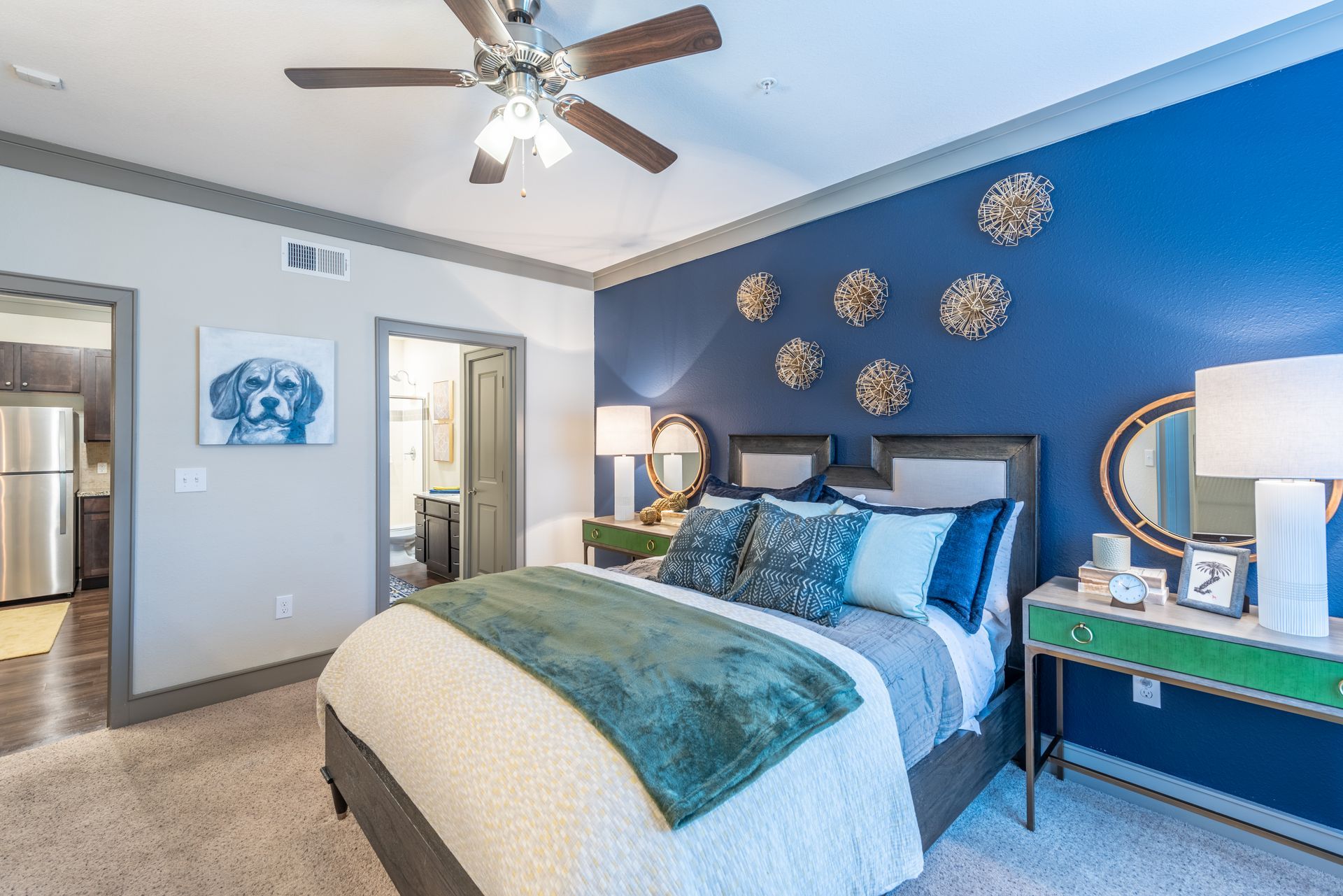 A bedroom with a bed and a ceiling fan at Marquis Seven Lakes offers apartments for rent near Cinco Ranch, TX.