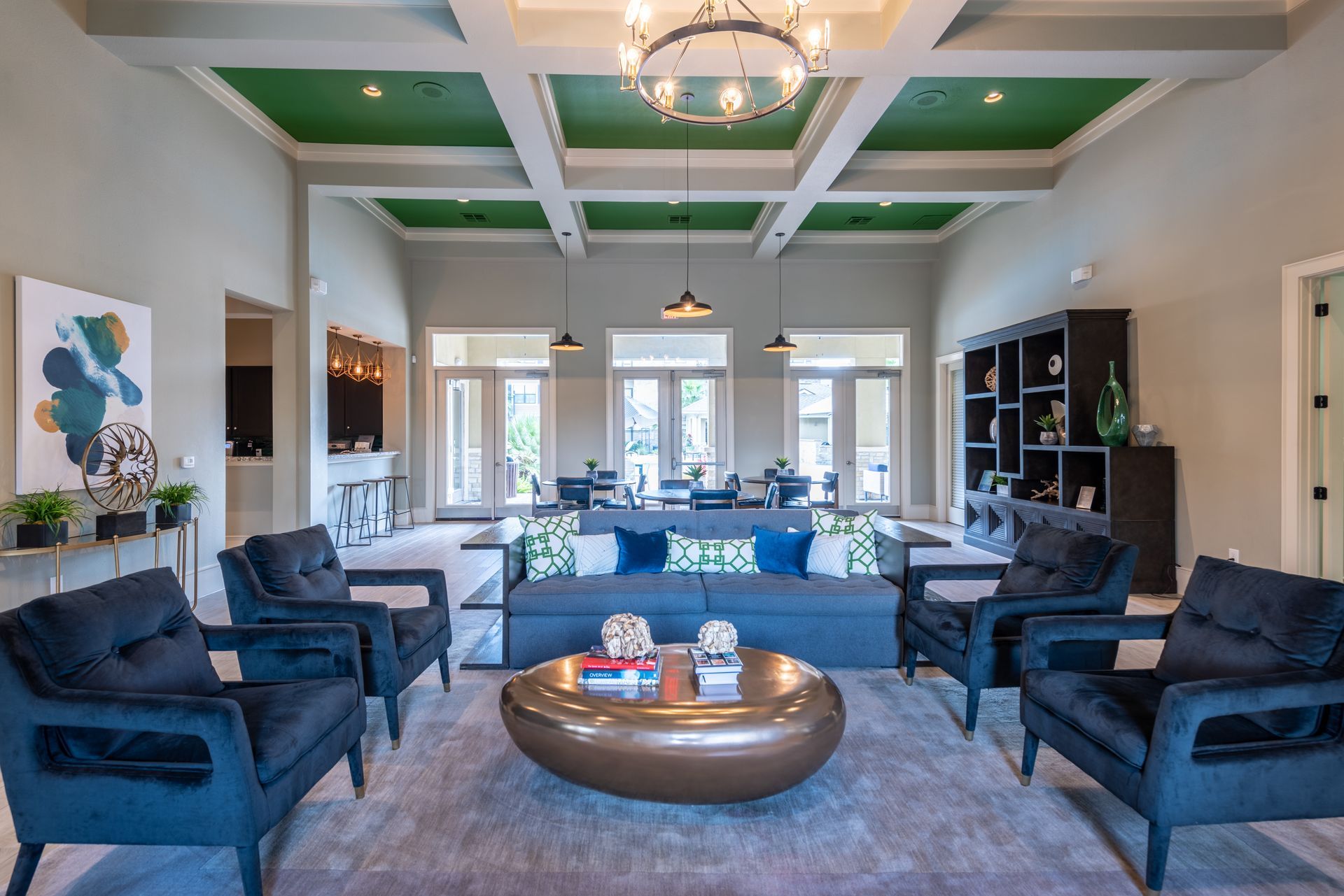 A clubhouse with a couch , chairs , and a coffee table at Marquis Seven Lakes, offers apartments in Katy, TX.