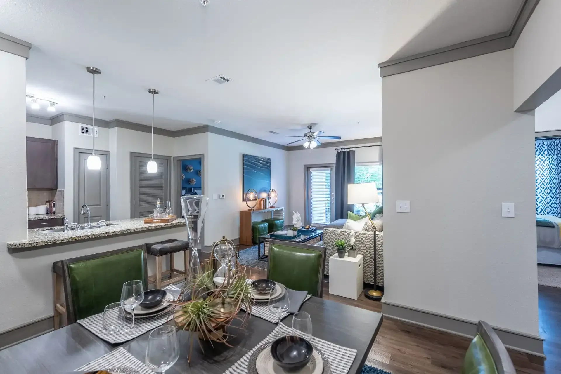 There is a dining table and chairs in the middle of the room at Marquis Seven Lakes offers apartments for rent in Katy, TX.