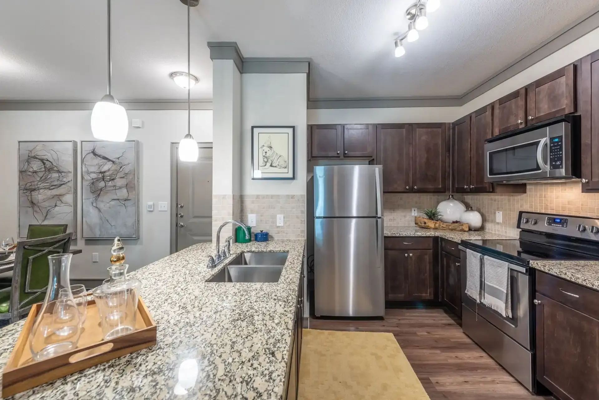 A kitchen with stainless steel appliances and granite counter tops at Marquis Seven Lakes offers Cinco Ranch apartments for rent.
