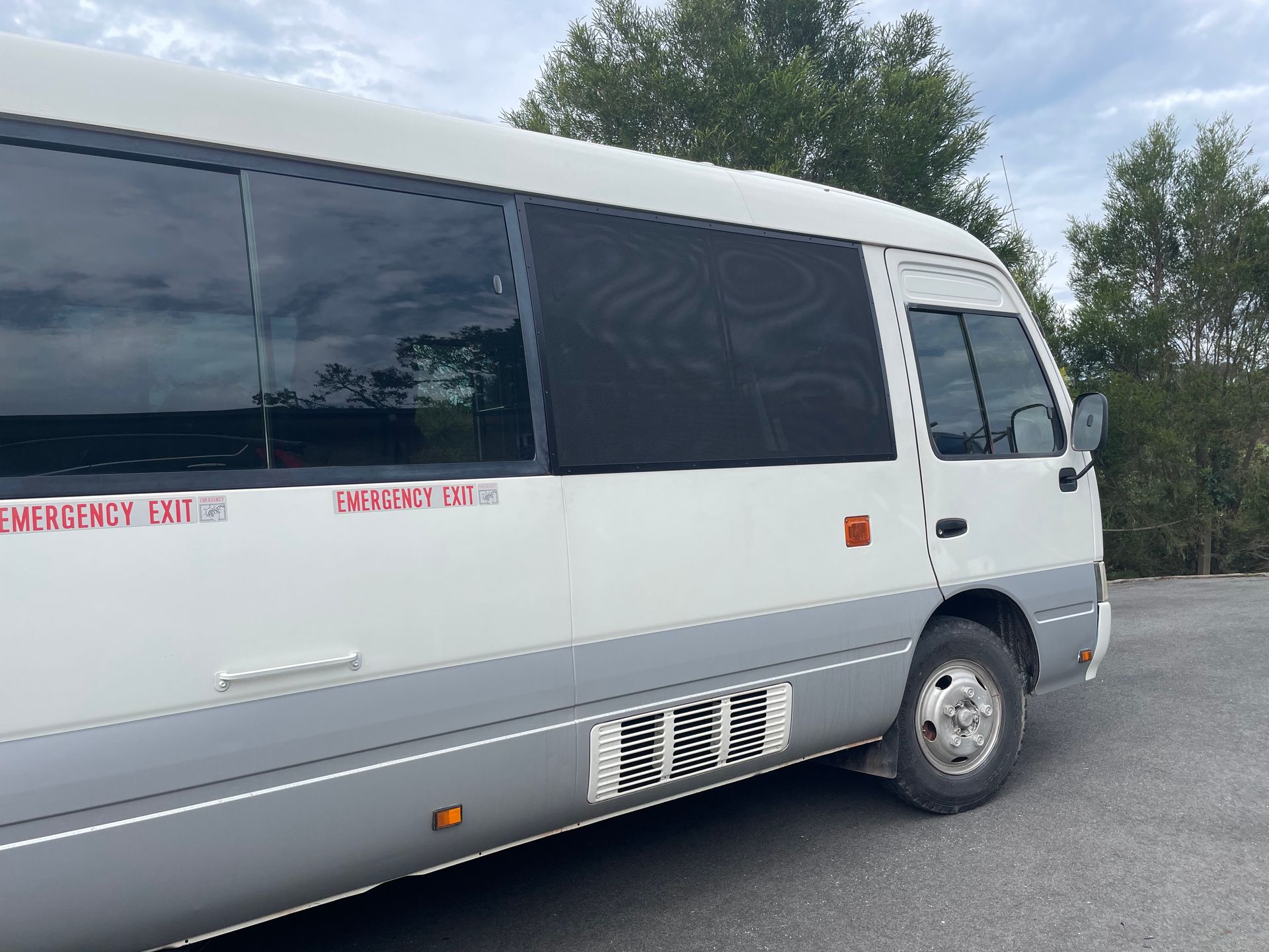 Image of a mini bus with secureview stainless steel security screen on the drivers side window