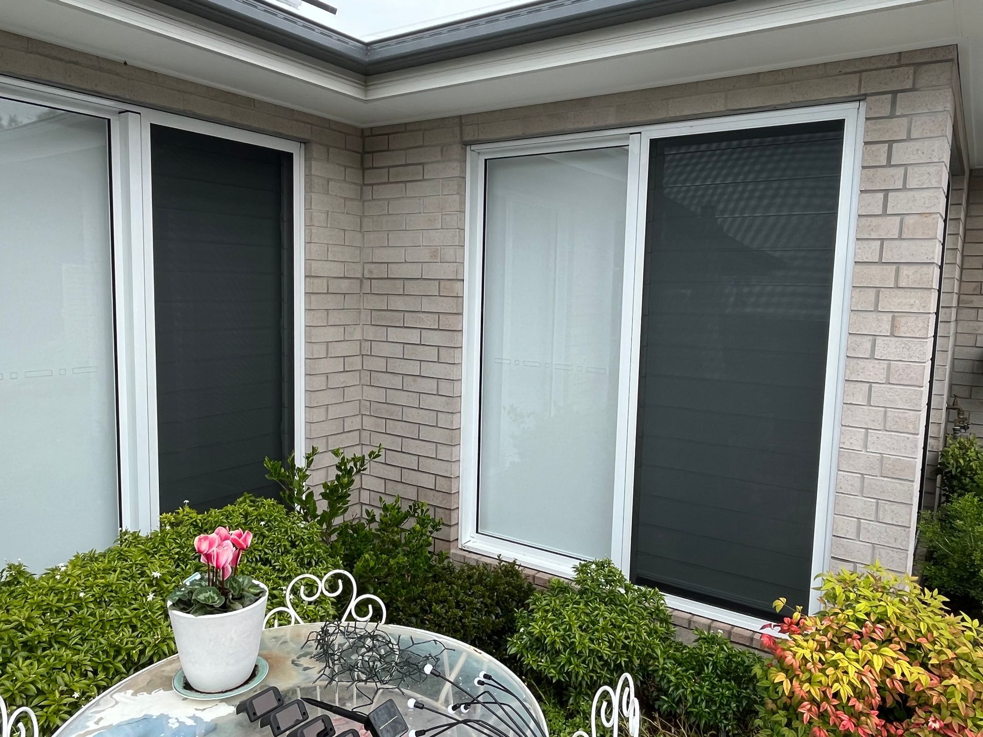 Secureview security screens on 2 windows on a house looking from outside