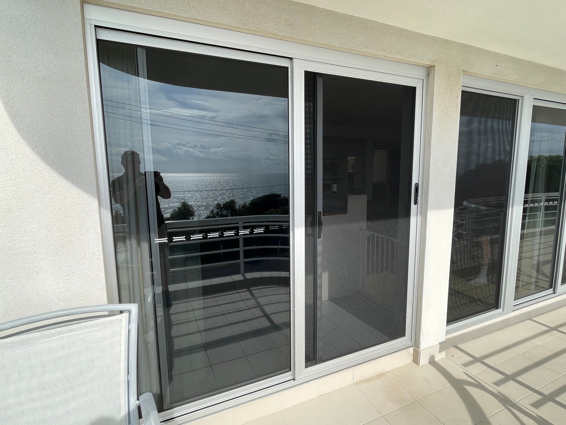 Image of 2 sets of new glass sliding doors & new secureview stainless steel sliding security doors with white frames