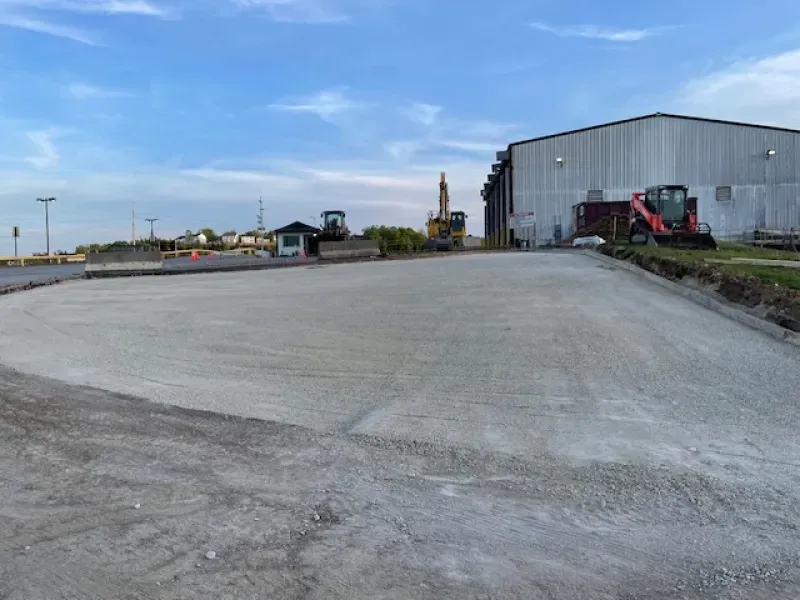 A large building with a lot of machinery in front of it.