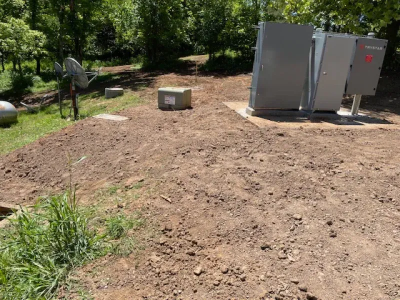 A dirt field with a box in the middle of it