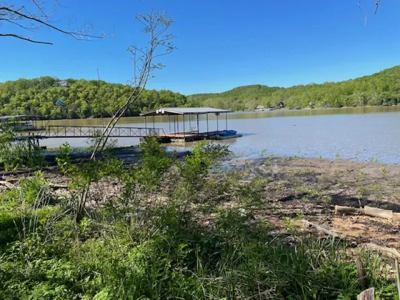 A large body of water with a dock in the middle of it.