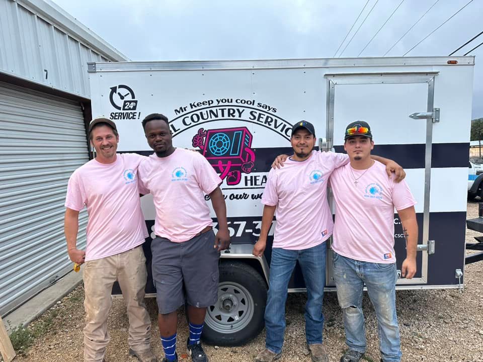 A group of men are posing for a picture in front of a trailer.