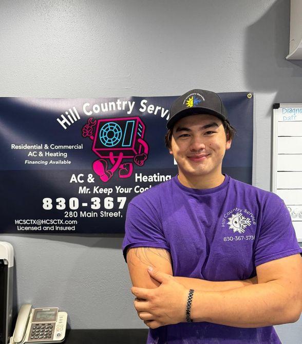 A man standing in front of a sign that says hill country service