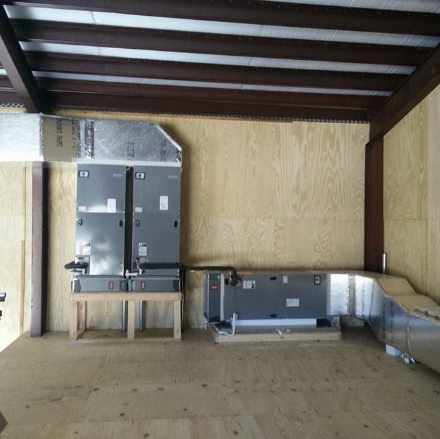 A room with a ceiling that has a few boxes on it