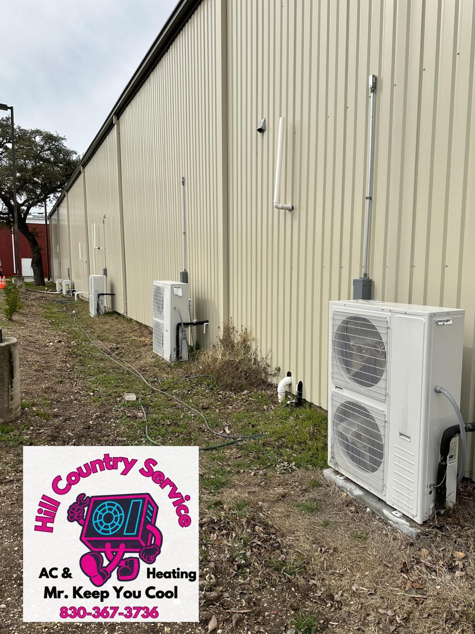 There are a lot of air conditioners on the side of a building.