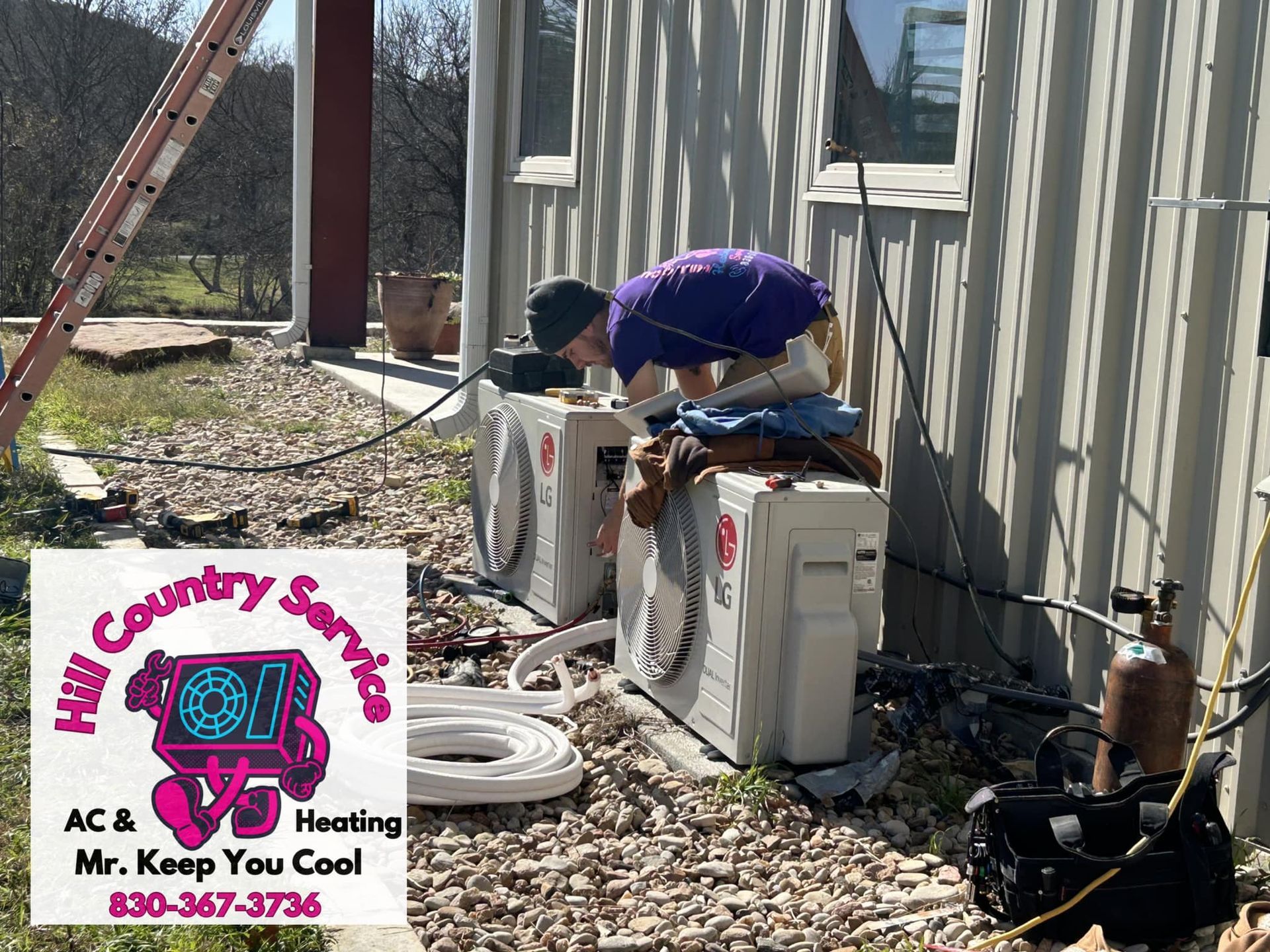 A man is working on an air conditioner outside of a building.