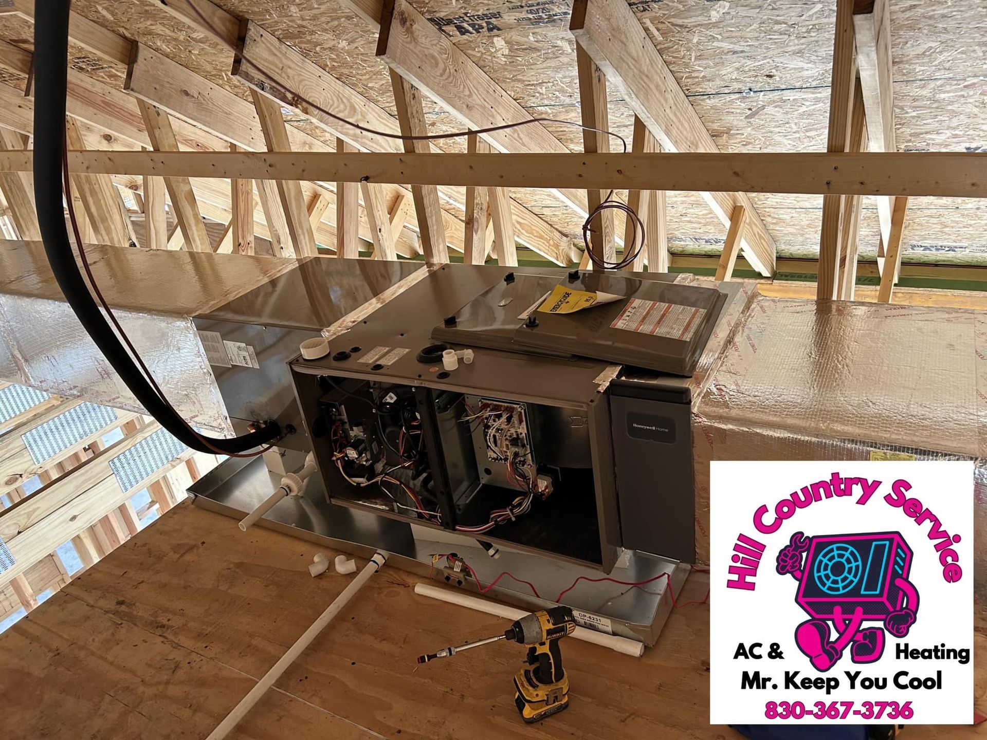 An air conditioner is being installed in a house under construction.