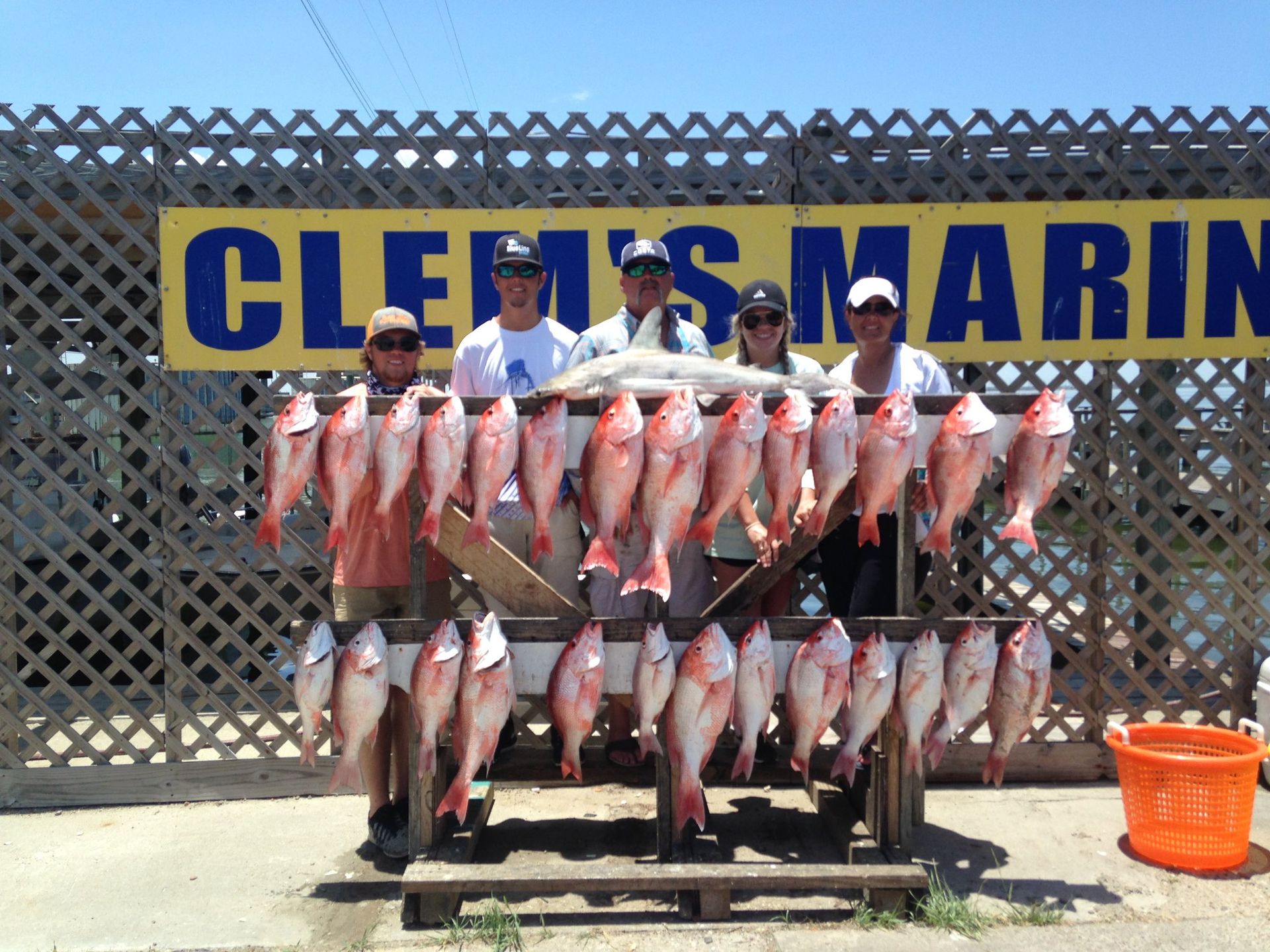 A group of people standing in front of a sign that says cleis marin