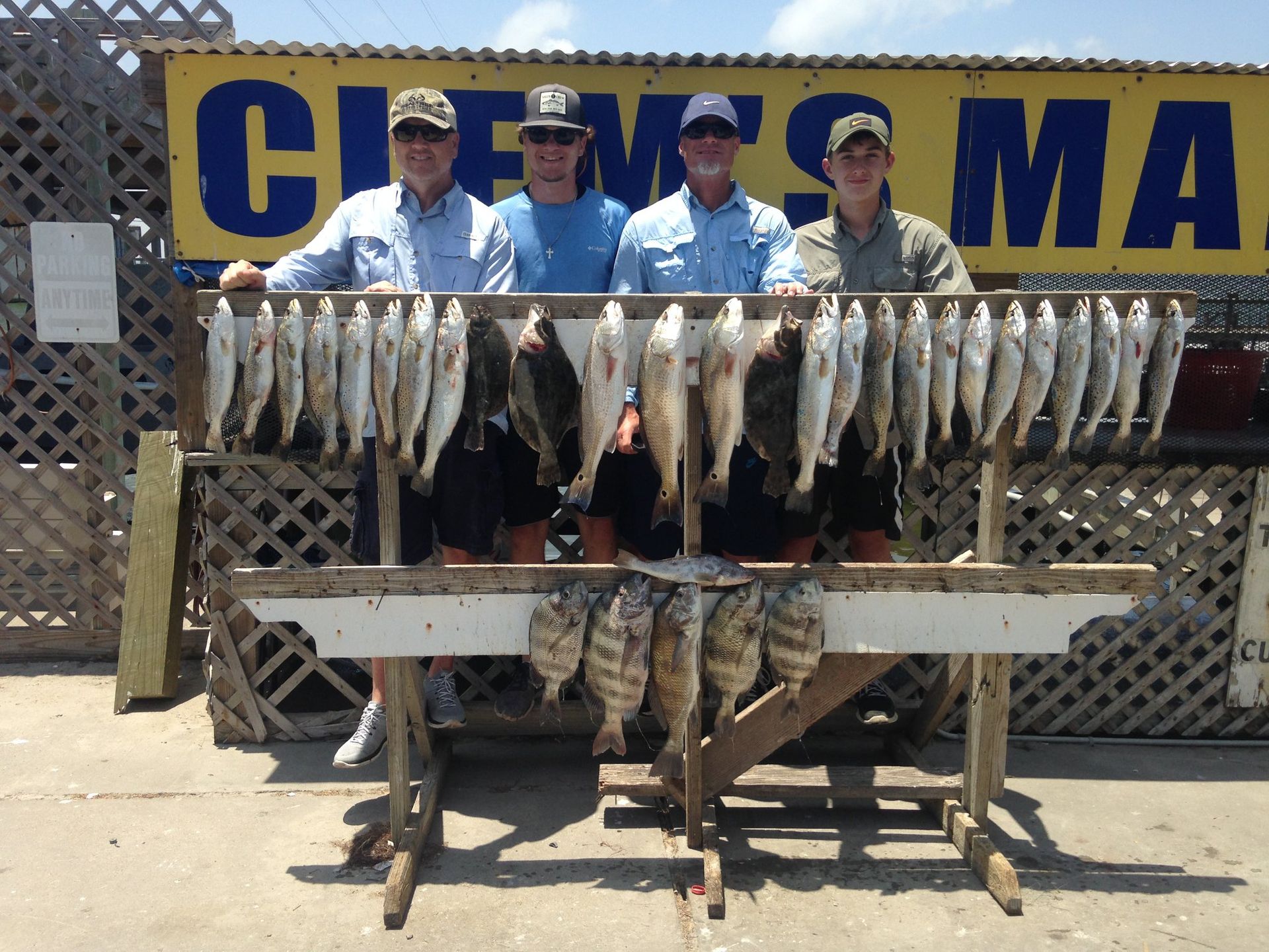 A group of men standing in front of a sign that says ' crew 's marina '