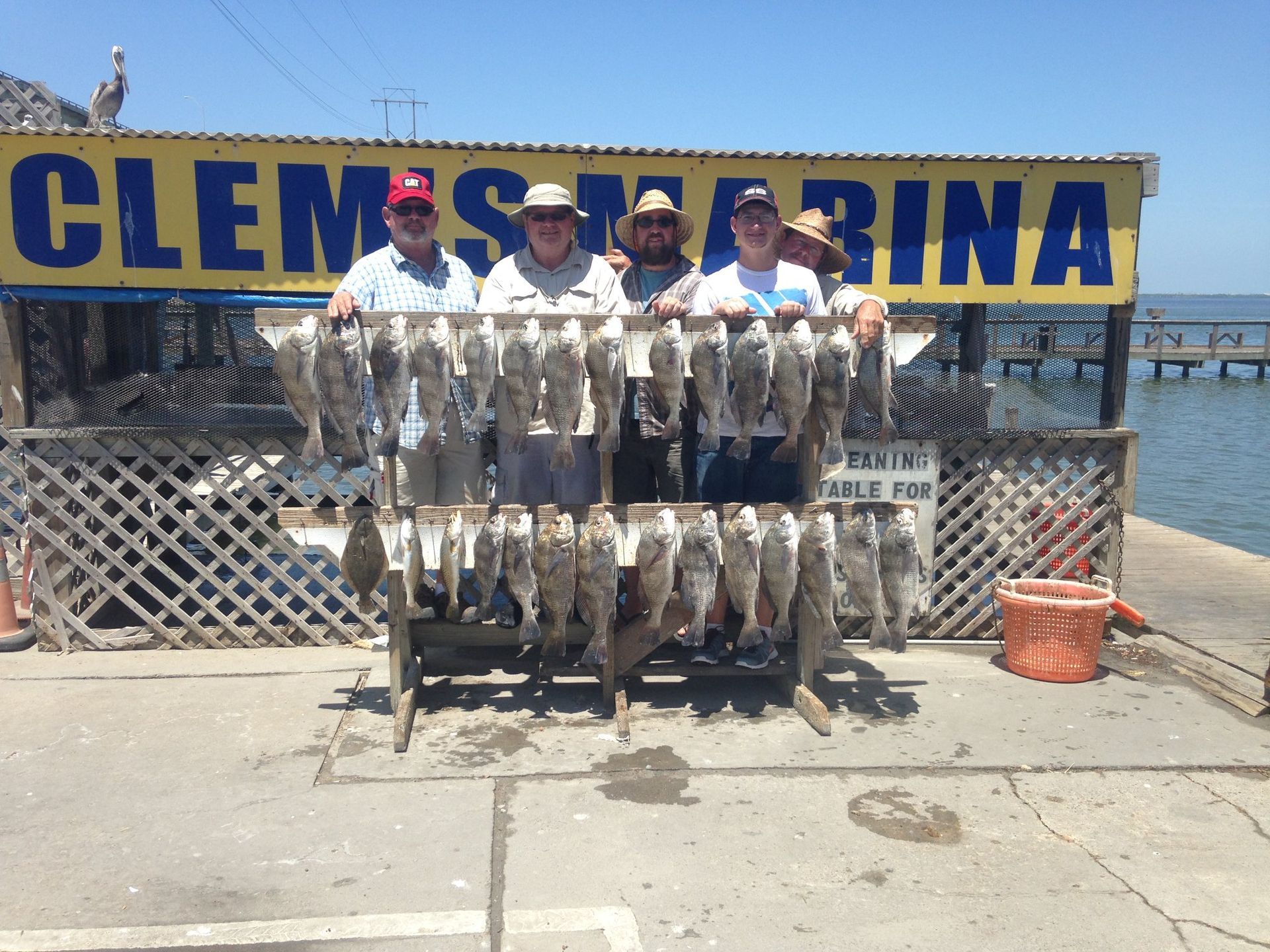 A group of men standing in front of a sign that says clemens marina