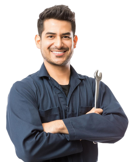 A man in a blue jumpsuit is holding a wrench and smiling.